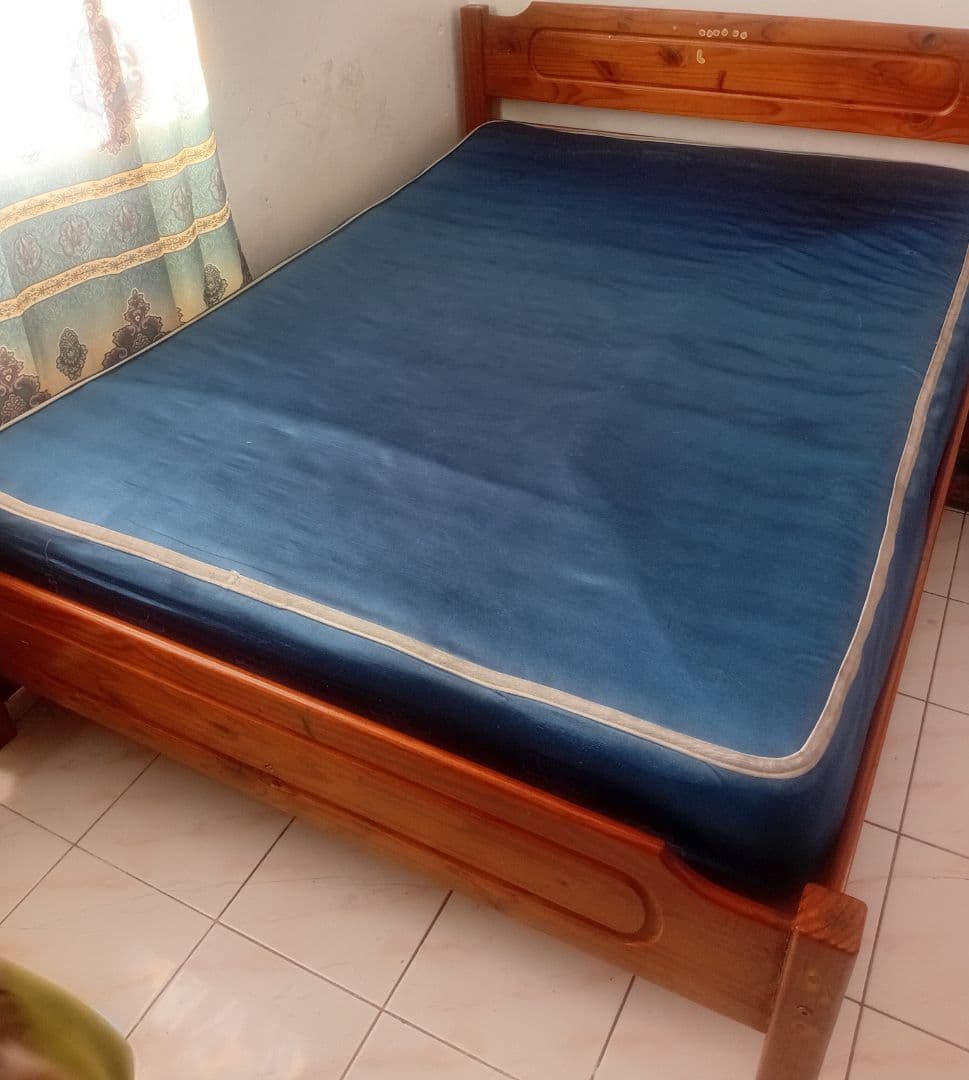 Wooden Bed Frame with Blue Mattress - Image 1 of 2